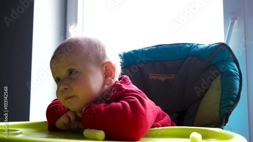 Cute blue eyes baby boy with a corn sticks in his hands. 