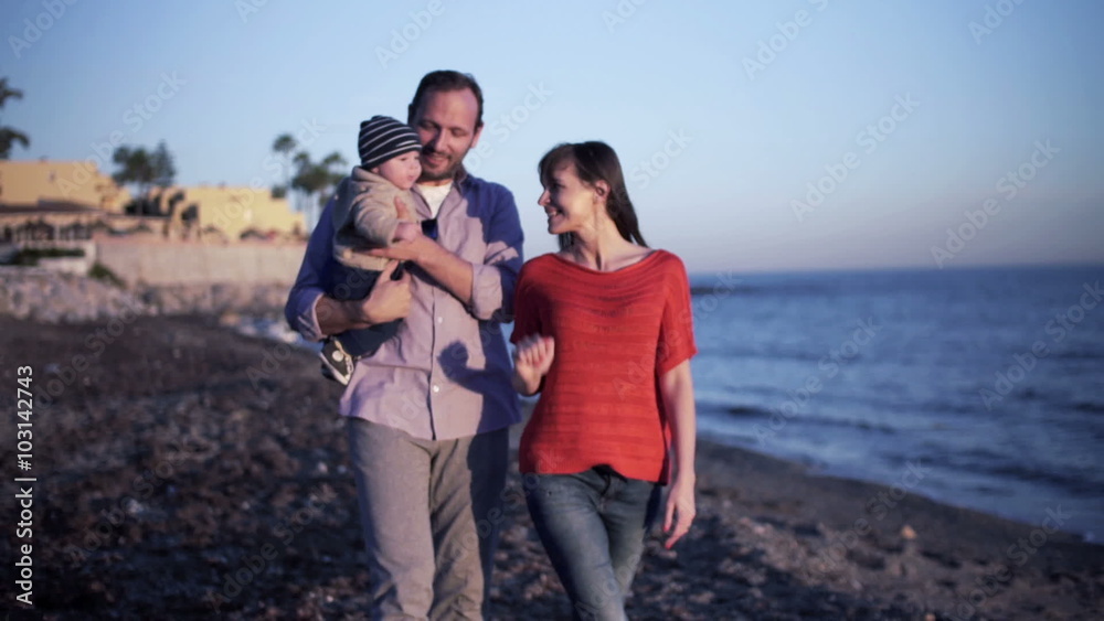 Young happy couple s walking with small baby on the beach
Young happy couple s walking with small baby on the beach