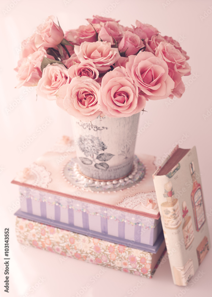 Roses in a vase over a girly box and vintage books Stock Photo | Adobe Stock