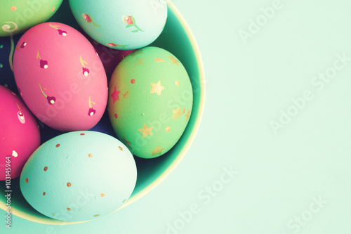 Vintage pastel easter eggs over mint background