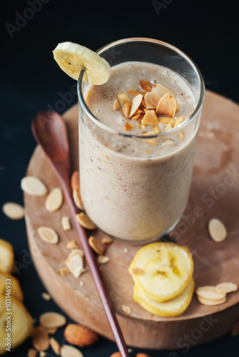 Fruit banana smoothies with milk, almond, flakes photo