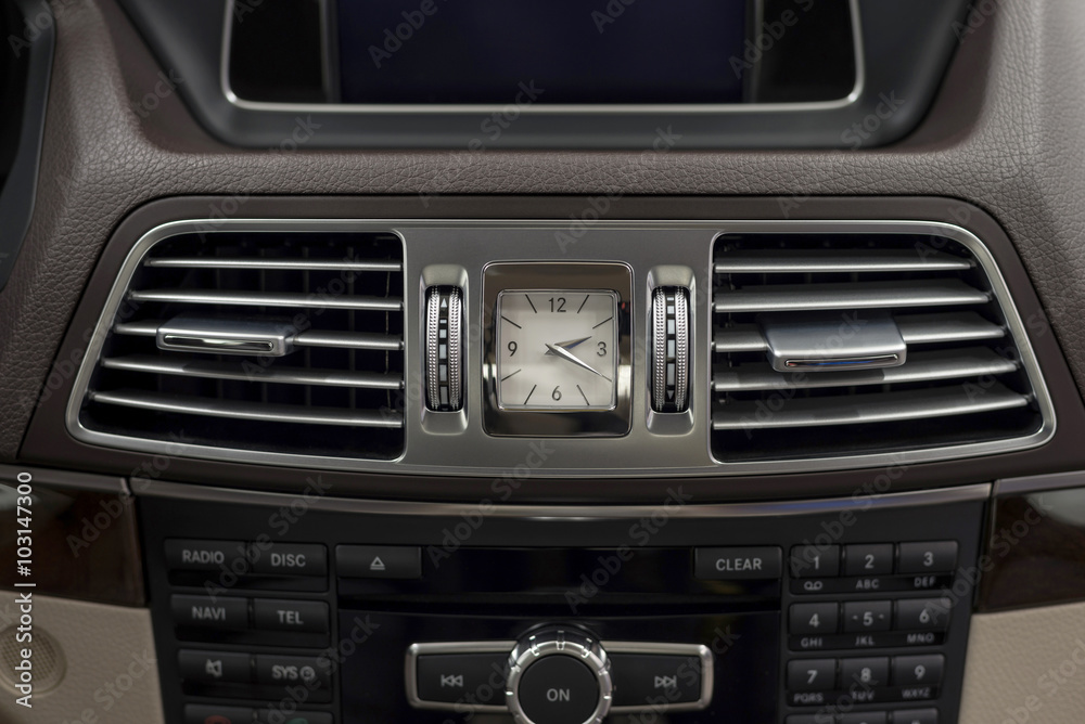 Modern car dashboard with clock and ventilation. Interior detail. Modern car dashboard with clock and ventilation. Interior detail.
