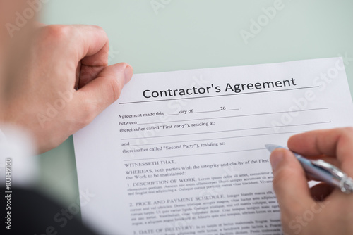 Person Hand Over Contractor's Agreement Form