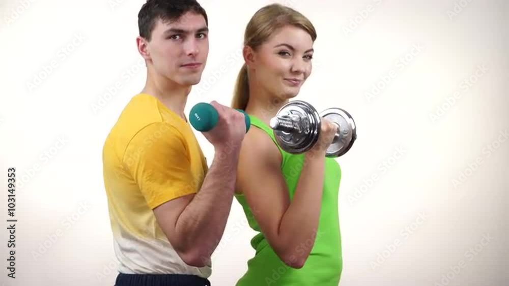 Couple exercising with dumbbells lifting weights 4K Couple exercising with dumbbells lifting weights 4K