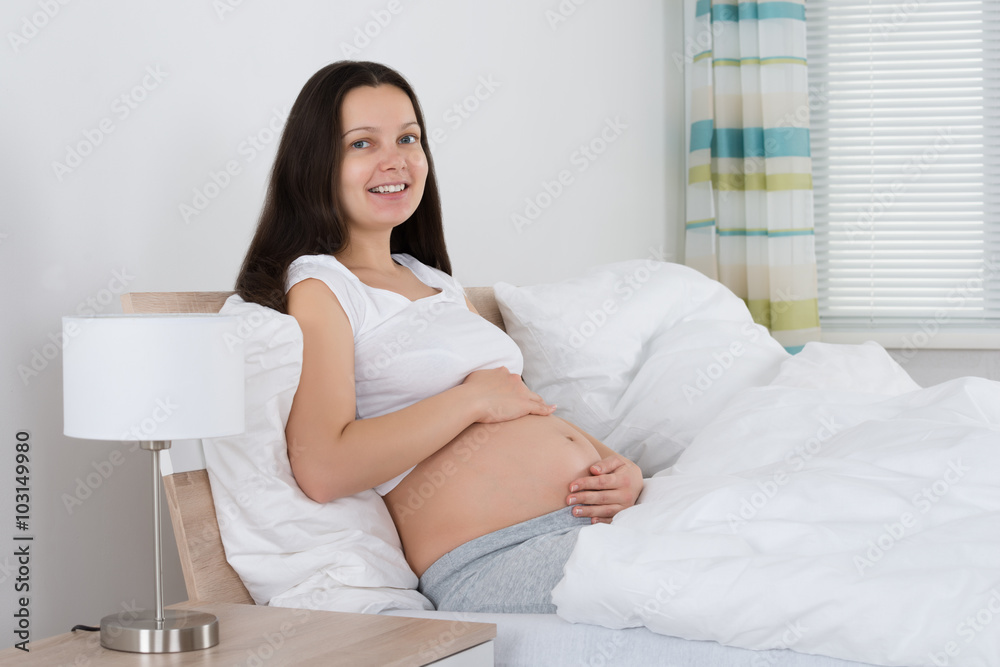 Pregnant Woman Sitting On Bed Pregnant Woman Sitting On Bed