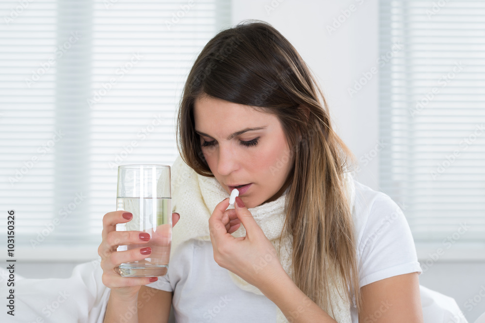 Young Woman Taking Pills And Glass Of Water Young Woman Taking Pills And Glass Of Water