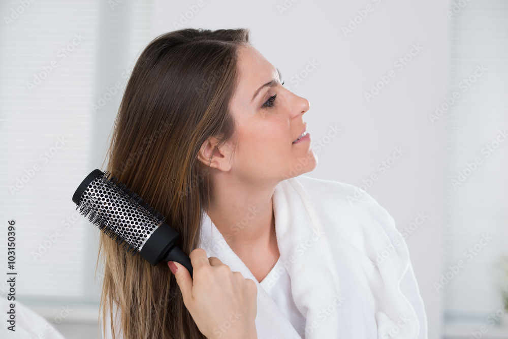 Fototapeta premium Woman Combing Her Hair
