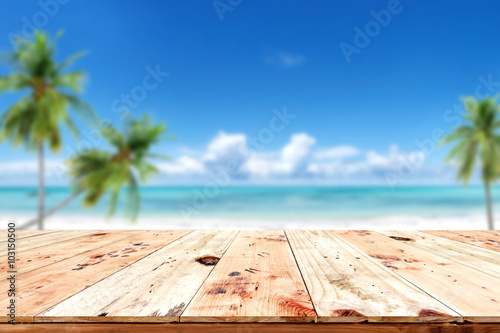 Fototapeta Naklejka Na Ścianę i Meble -  Top of wood table with blurred sea and blue sky background - Empty ready for your product display montage. Concept of beach in summer
