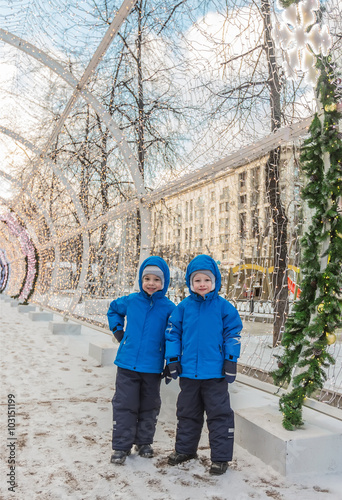 Five-year-old twins, on the street decorated by Christmas in Moscow © Irina Rogova