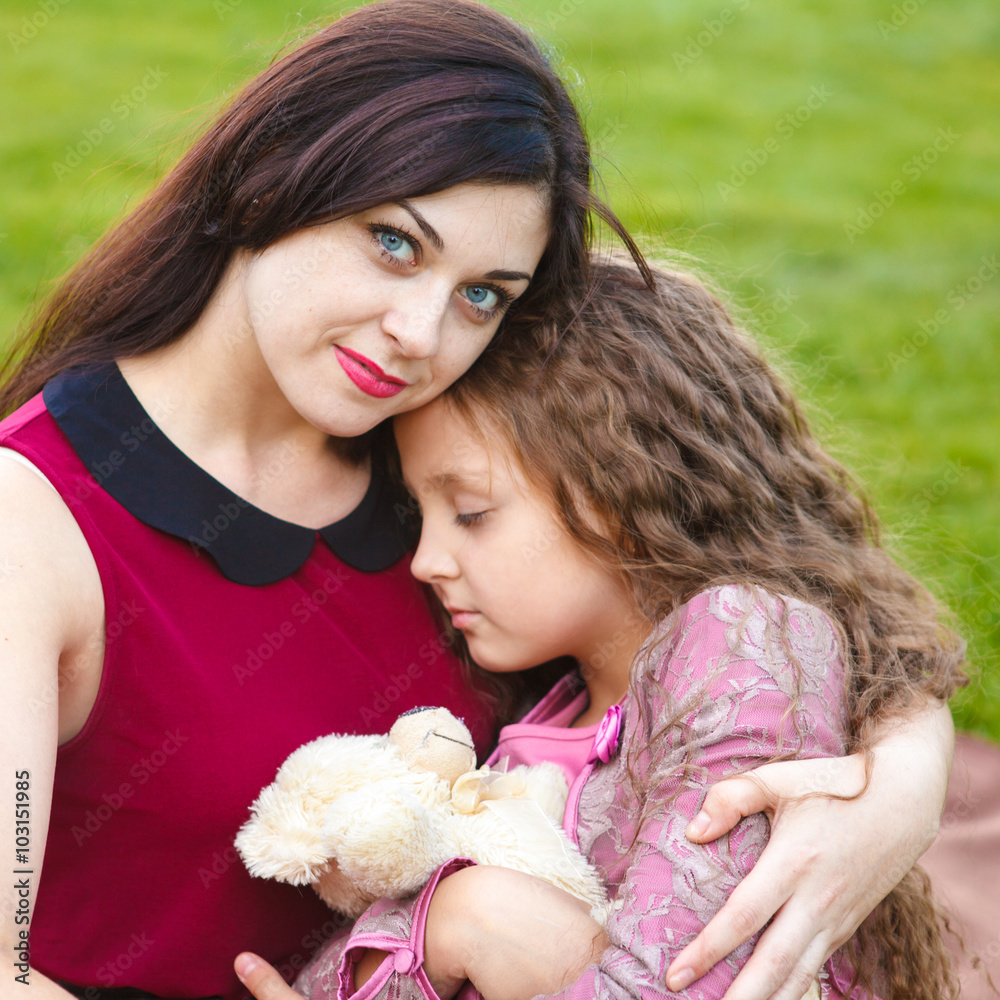 Mother hugs daughter in the park Mother hugs daughter in the park