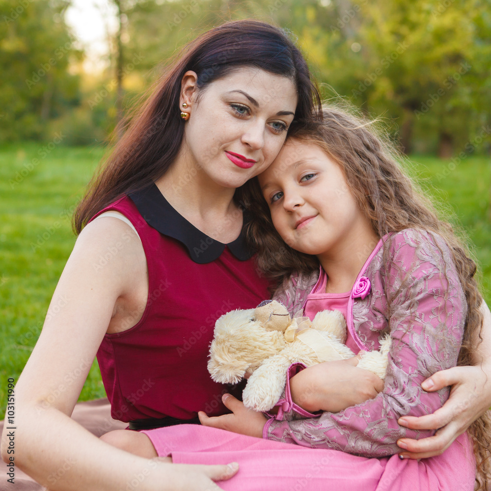 Mother hugs daughter in the park Mother hugs daughter in the park