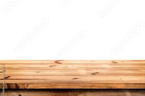 Empty wooden table for product placement or montage with focus to the table top in the foreground, with white background.