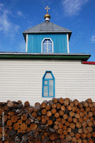 Woodpile at christian church building photo