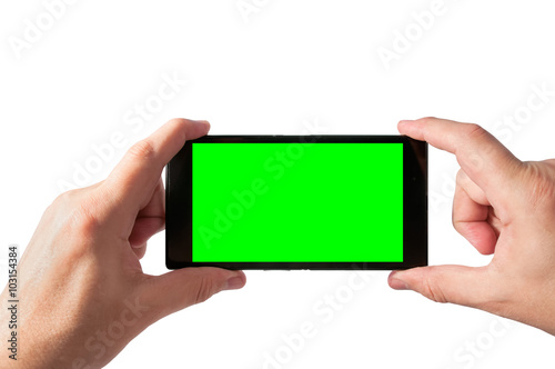 Man holds in two hands smartphone in landscape mode with green screen isolated on white. Chroma key screen for placement of your own content.
