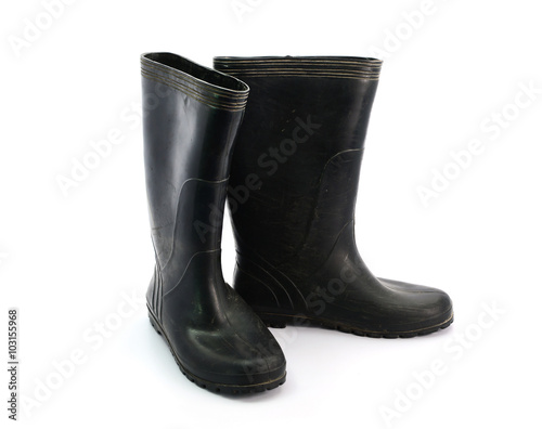 dirty black rubber boots isolated on white background