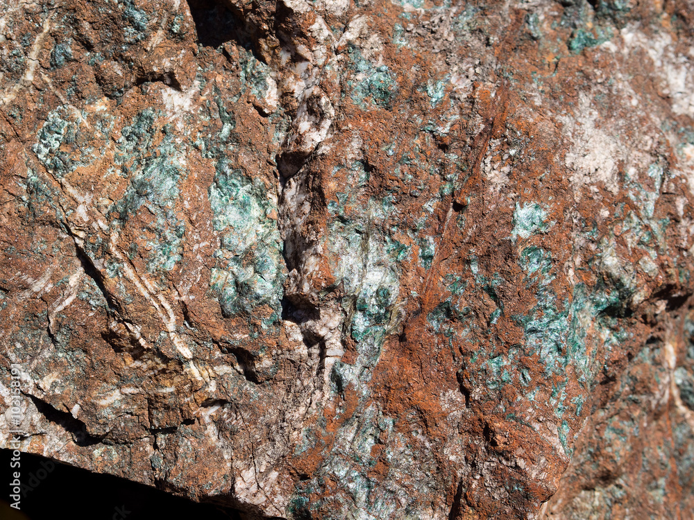 Cooper inclusions on the red surface of stone. Cooper inclusions on the red surface of stone.