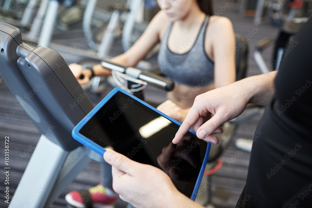 close up of trainer hands with tablet pc in gym close up of trainer hands with tablet pc in gym