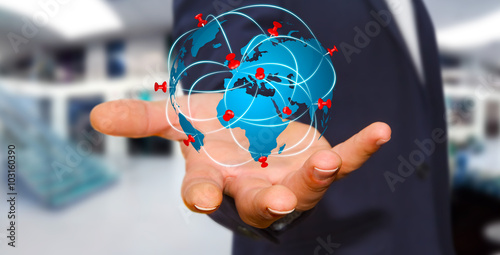 Businessman holding digital world map in his hands