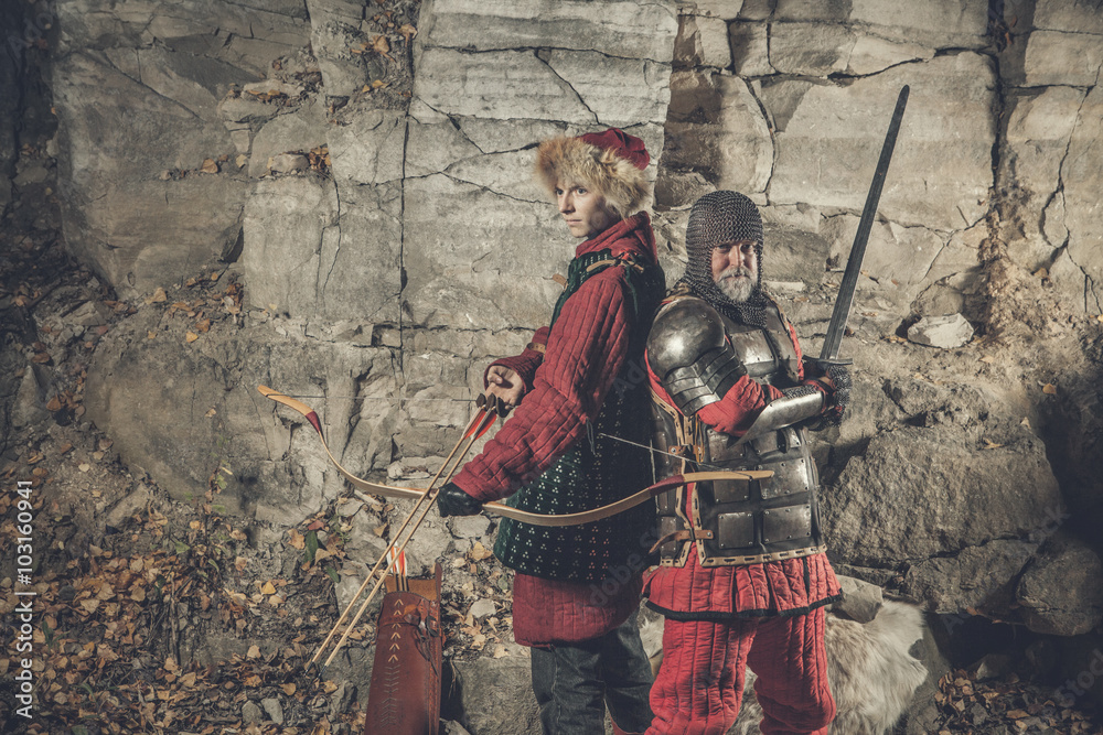 Naklejka premium Old knight with the sword and his squire