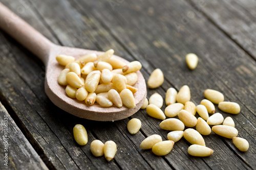 pine nuts on wooden spoon photo