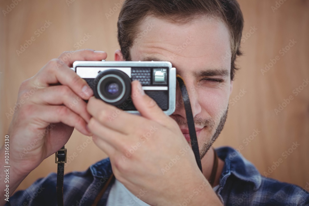 Handsome hipster taking picture with retro camera Handsome hipster taking picture with retro camera
