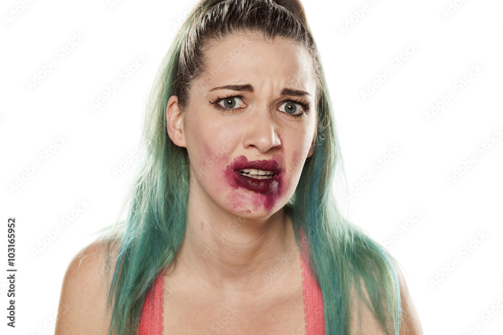 frightened beautiful young woman with smeared lipstick frightened beautiful young woman with smeared lipstick