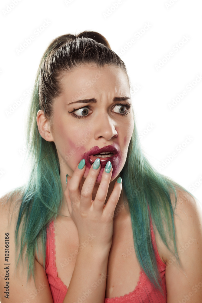 frightened beautiful young woman with smeared lipstick frightened beautiful young woman with smeared lipstick