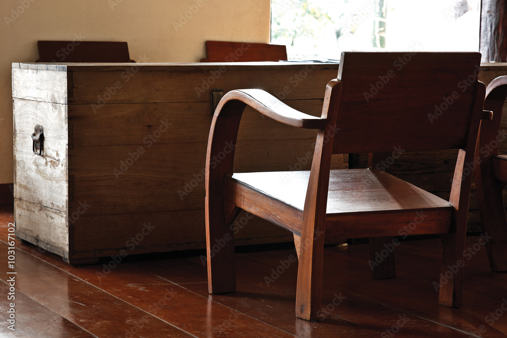 Old wooden chiar with big old wooden chest in living room Old wooden chiar with big old wooden chest in living room