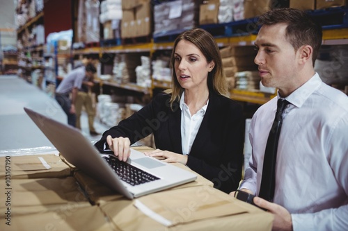 Warehouse managers using laptop