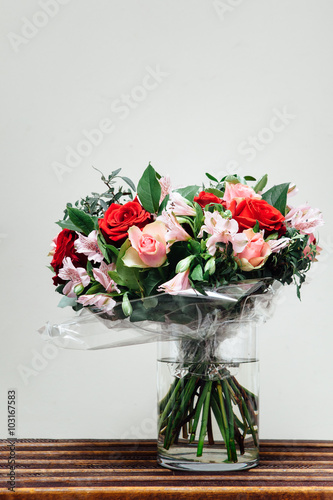 flowers bouquet on wooden planks, light background