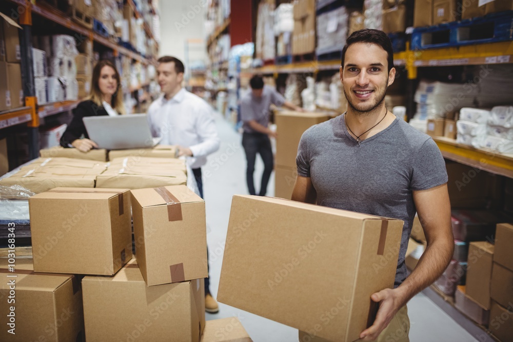 Smiling man carrying box Smiling man carrying box