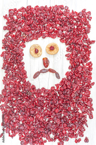 Fototapeta Naklejka Na Ścianę i Meble -  Sad face made of dried fruits on white wooden background