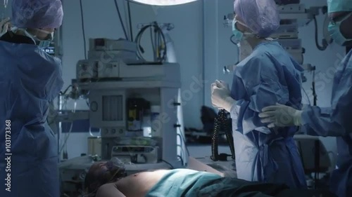 Medical Team Performing Defibrillation in Modern Operating Room. Shot on RED Cinema Camera.
