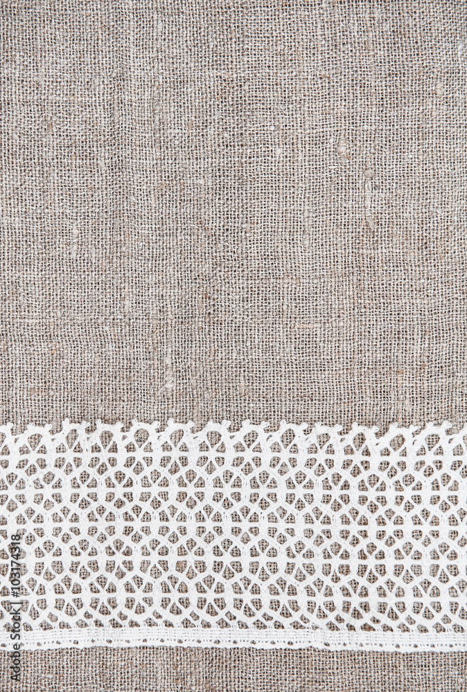 Fototapeta premium Vintage background with lace fabric on burlap
