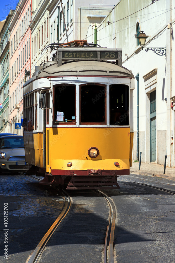 Beautiful traditional yellow tram in the streets of Lisbon, Portugal, in summer