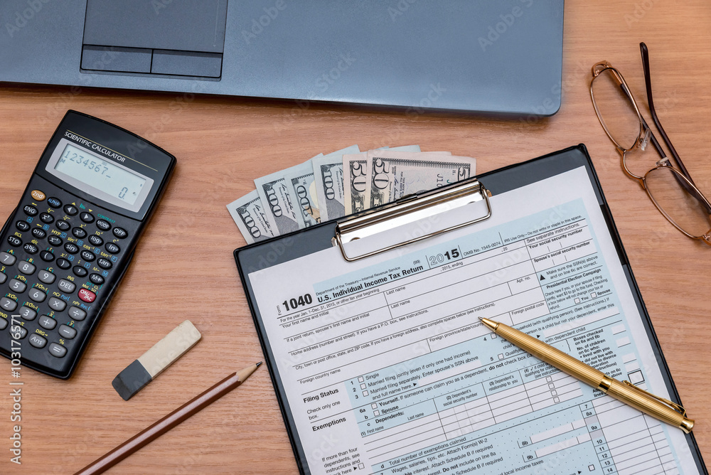 tax form with computer on table tax form with computer on table