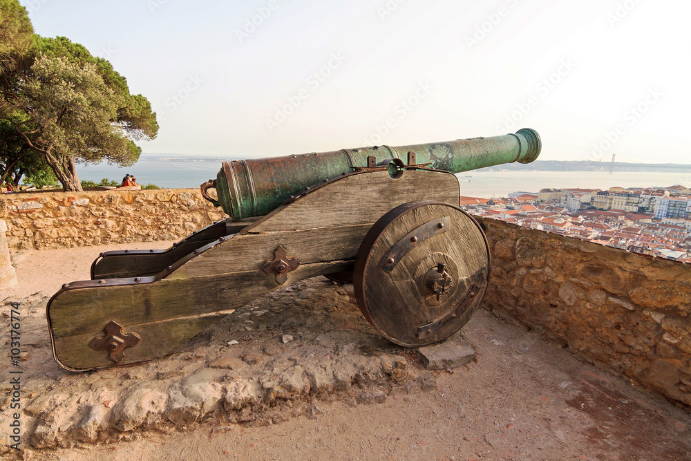 Big ancient cannon at castle Sao Jorge in Lisbon, Portugal, looking over the city