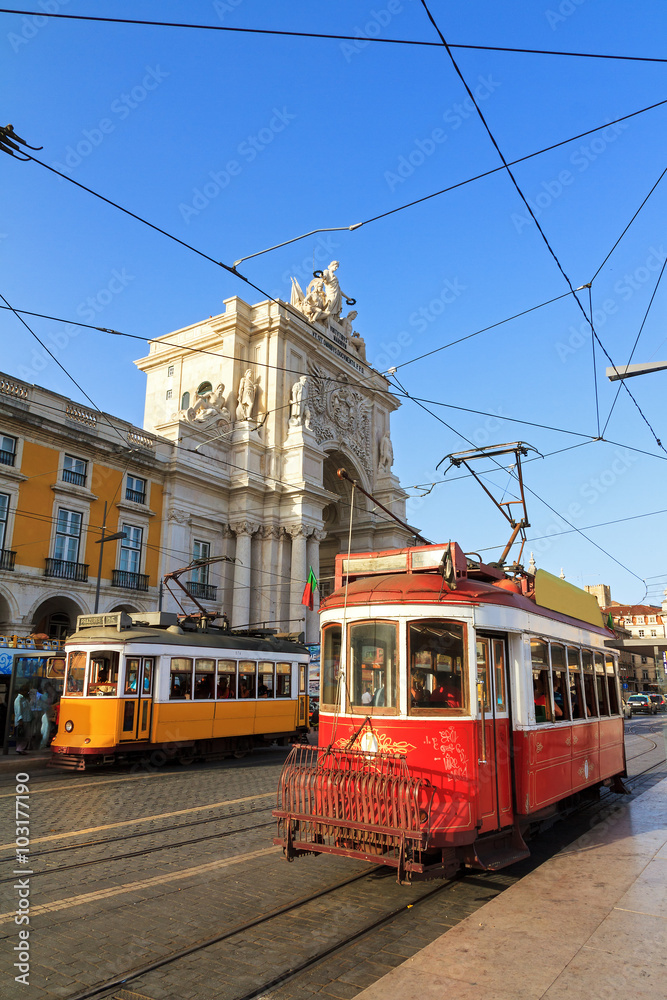 Beautiful traditional red and yellow trams in the streets of Lisbon, Portugal, in summer