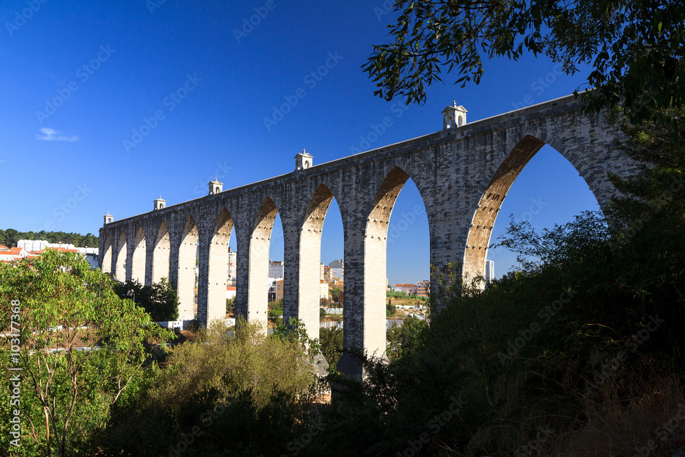 Beautiful view of the Aguas Livres Aqueduct on a summer day in Lisbon, Portugal