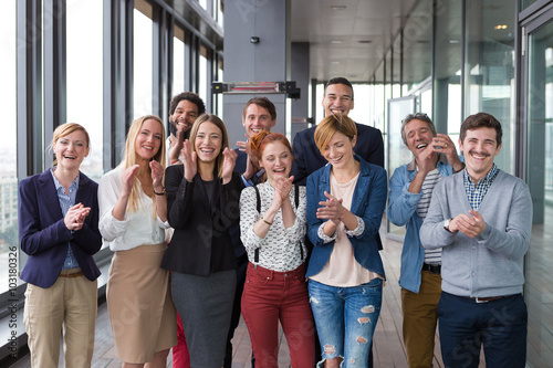 Group shot of business people in modern office hall.