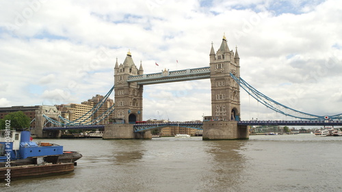 Slow motion view downstream across the River Thames towards Tower Bridge, London.