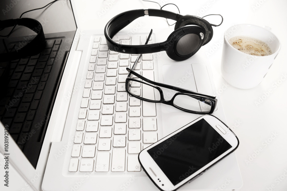 laptop with glasses and earphones in the office laptop with glasses and earphones in the office