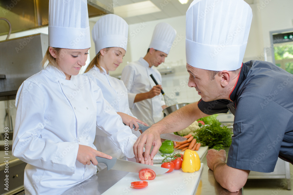 Chef guiding trainee