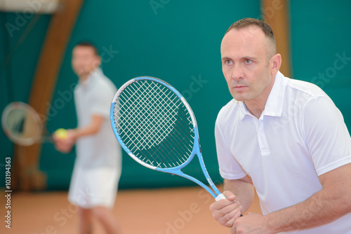 Two men playing tennis © auremar