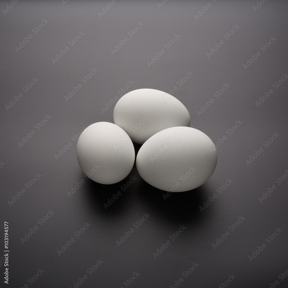 White eggs on black background White eggs on black background