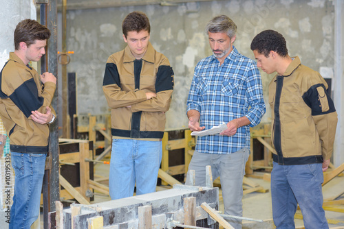 Принти на полотні Teacher with three students in practical class