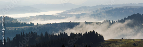 cold fog on hot sunrise in mountains © Pellinni