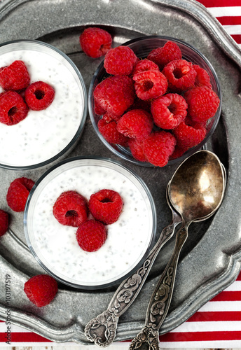 Yogurt with chia seeds and fresh raspberries for healthy breakfa photo