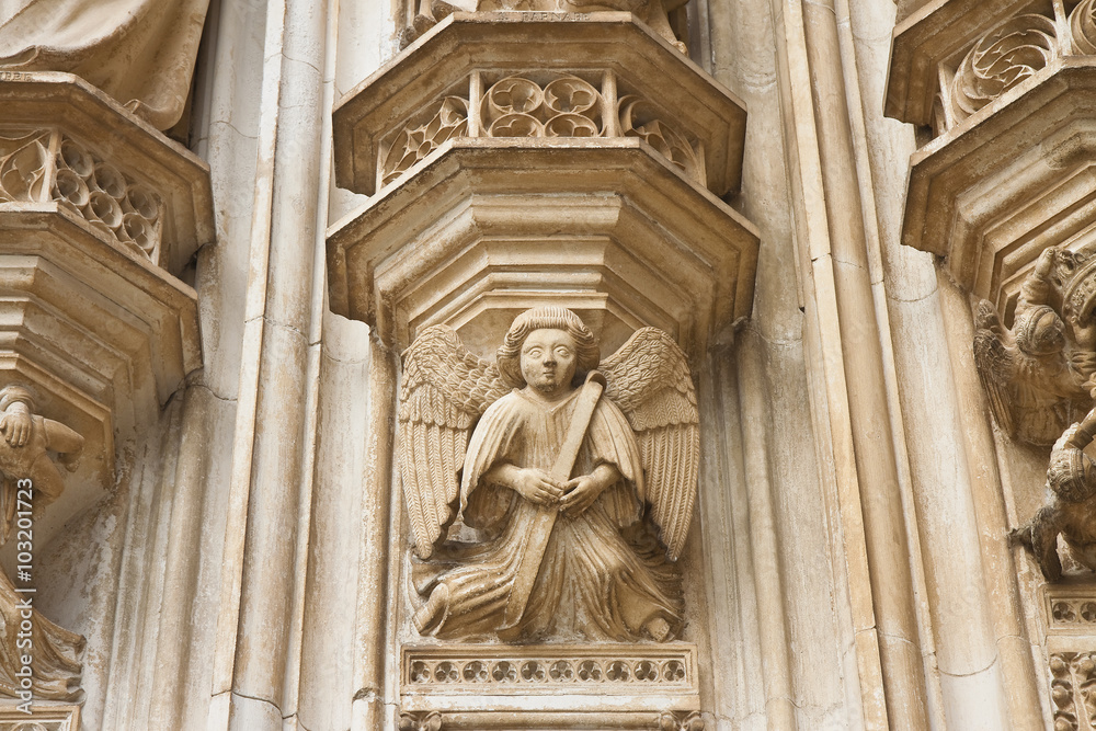 Stone angel on the facade of Batalha cathedral in Portugal (Europe)