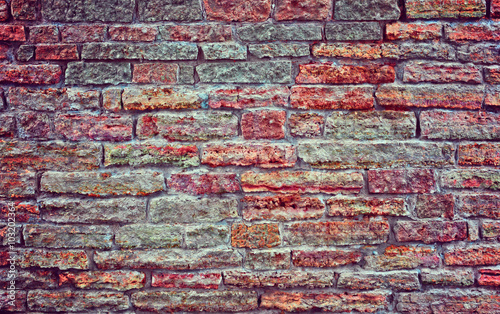 Old brick wall.  Apply color and lighting effects. Colorful picture. Deep, rich, bright colors.  Vignetting. Art reception.